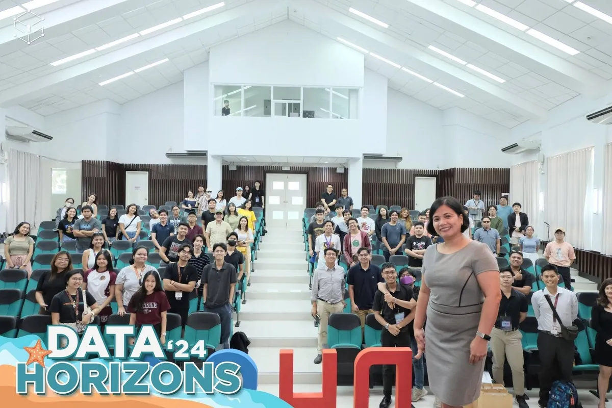 Participants and organizers posing inside the Data Horizons 2024 venue