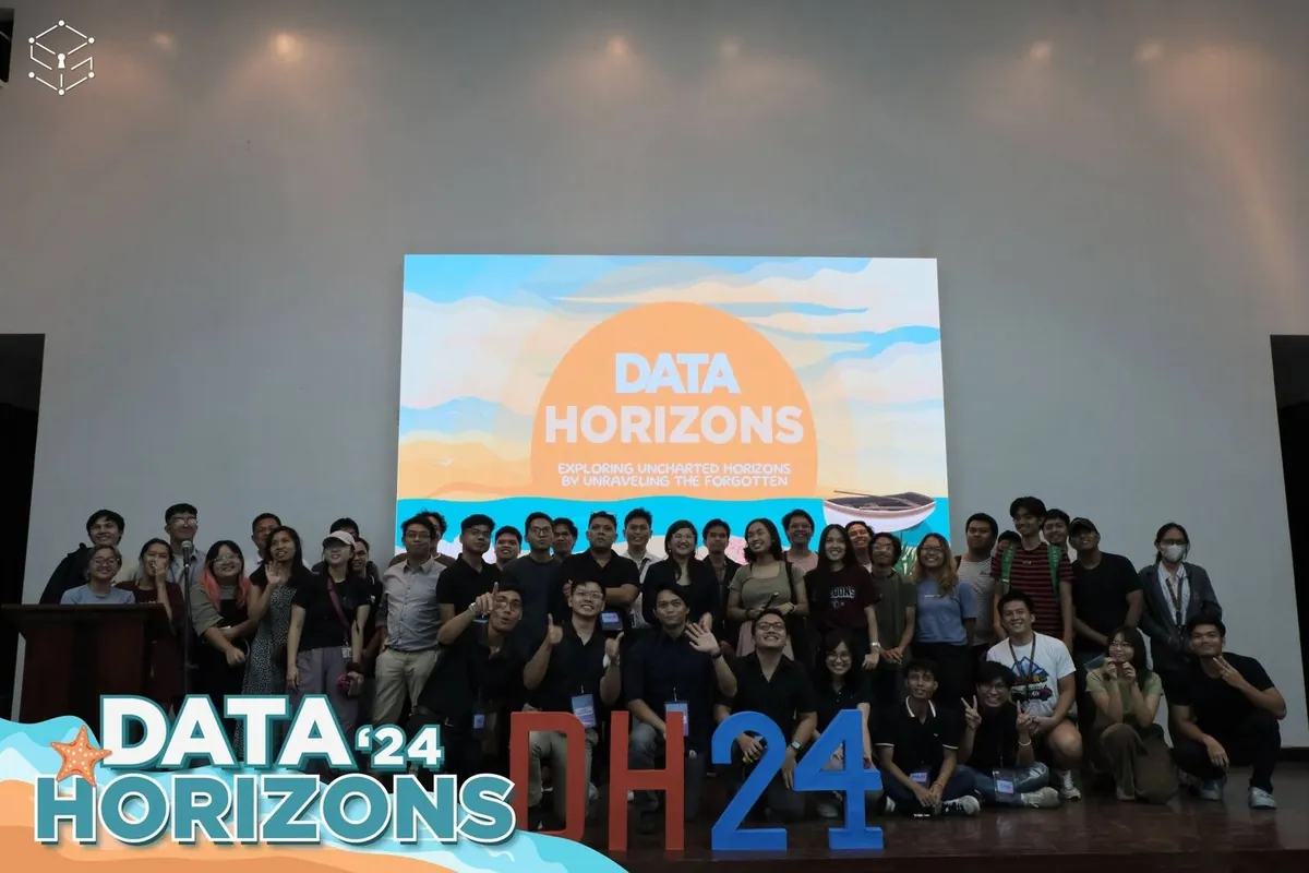 Data Horizons 2024 organizers posing in front of the symposium screen